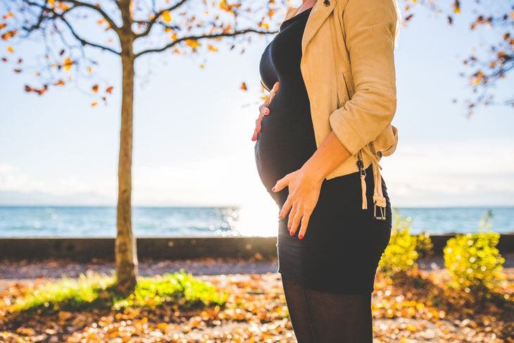 Pregnant Woman Walking In Fall