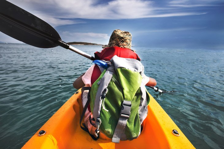 Expert Backpacking Kayaker Runs On Water In The Ocean